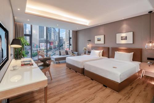 Postel nebo postele na pokoji v ubytování Yunjian Hotel