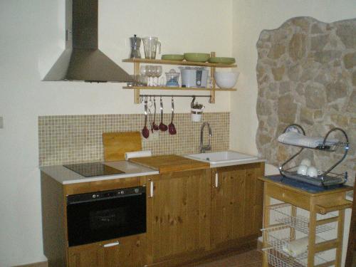 a kitchen with a sink and a stove top oven at Ca l'Estruch in Vallclara