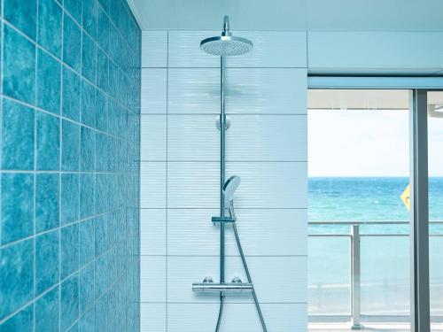 a shower in a bathroom with a view of the ocean at Blue Ocean Awaji in Sumoto