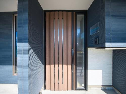 a wooden door on the side of a building at Blue Ocean Awaji in Sumoto