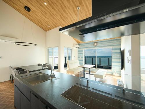 a kitchen with a sink and a view of the ocean at Blue Ocean Awaji in Sumoto