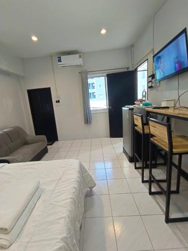 a room with a bed and a kitchen with a tv at Gift house in Hat Yai