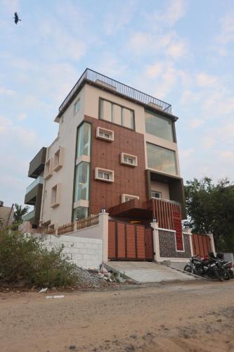 a building on the side of a street at MM Beach House & Party Hall in Chennai