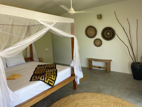 Postel nebo postele na pokoji v ubytování Palmera Zanzibar Eco Boutique Hotel