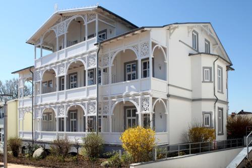a white building with white trim at AKZENT Waldhotel Spa Rügen in Göhren
