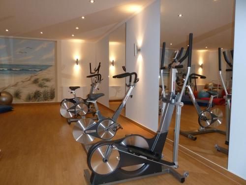 a gym with three exercise bikes in a room at AKZENT Waldhotel Spa Rügen in Göhren