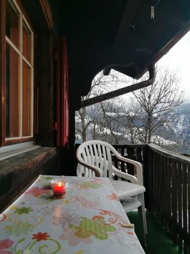 a table and two chairs on a balcony with a view at Chalet Sandgrube in Mörel