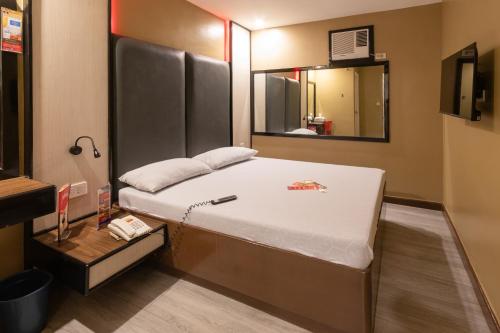 a bedroom with a large bed with a mirror at Hotel Sogo Cainta in Manila