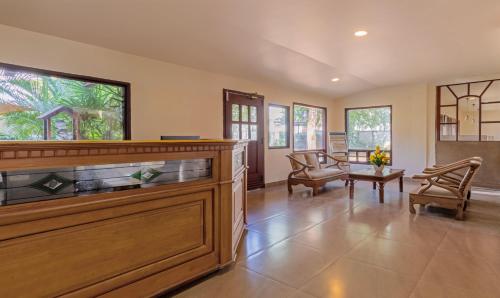 a large living room with a fish tank at Treebo Sadhoo Heritage in Kannur