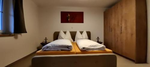 a bedroom with a bed with two pillows on it at Villa Hilda in Moosheim