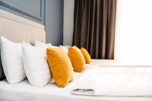 a row of yellow pillows on a bed at Grand Hotel Baku Central Park in Baku