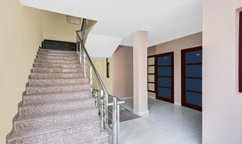 a set of stairs in a building with a door at Hotel King Palace Near CP 67 Mall Airport Road Mohali in Sohāna