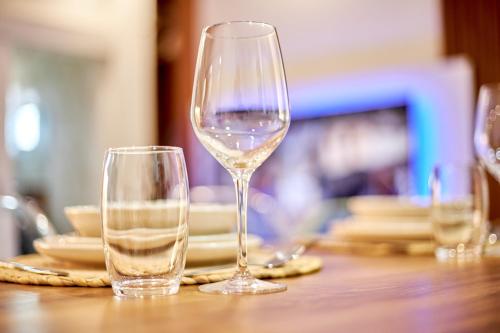two wine glasses sitting on top of a table at Résidence Alicia Grand studio luxueux et élégant in Bingerville