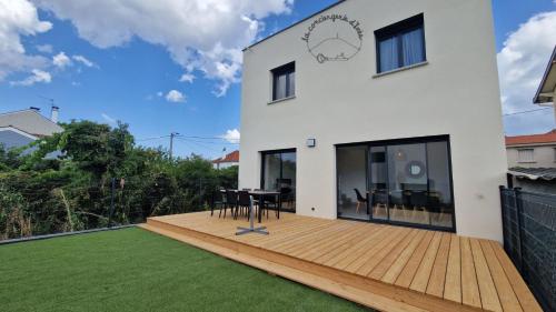 a large white house with a wooden deck at Le Lisbonne #Climatisation#Terrasse#Parking in Aubière