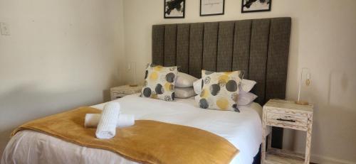 a bedroom with a large white bed with pillows at Carrington Guesthouse in Kimberley