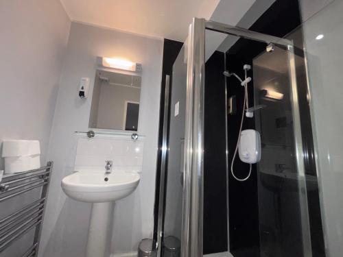 a bathroom with a shower and a sink and a toilet at Park View Rooms in Edinburgh