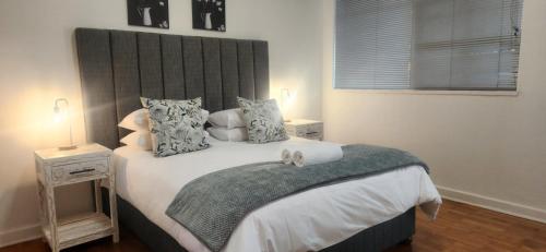 a bedroom with a large bed with a headboard at Carrington Guesthouse in Kimberley