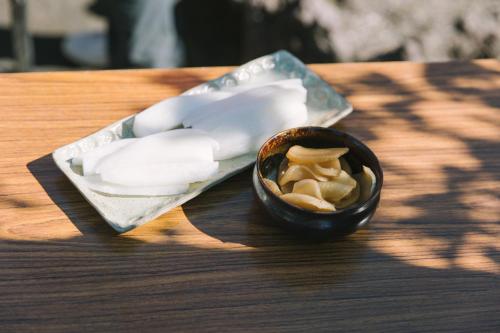 a small bowl of food on a wooden table at 火口に最も近い桜島のゲストハウスikoてらす in Kagoshima