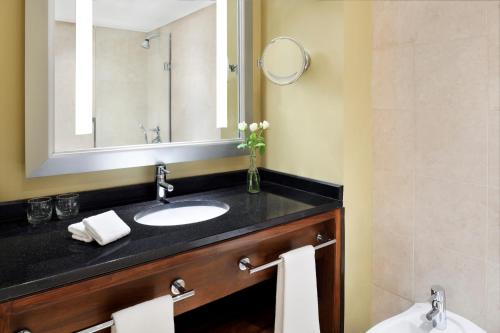 a bathroom with a sink and a mirror at InterContinental Amman Jordan by IHG in Amman
