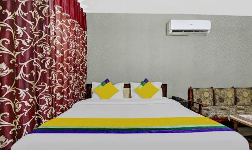 a bedroom with a bed and a red curtain at Hotel King Palace Near CP 67 Mall Airport Road Mohali in Sohāna