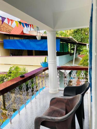 a balcony with a chair and a table at Hello entire villa varkala cliff in Varkala