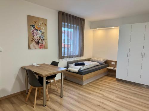a room with a bed and a table and a desk at Apartment, Zimmer, Ferienwohnung in Traitsching