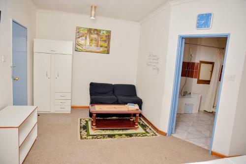 a living room with a blue couch and a table at Crystal Palace Hotel in Gaborone