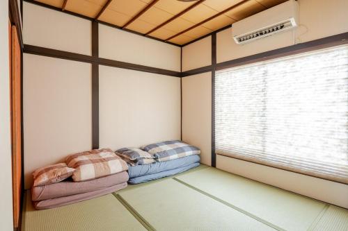 two beds in a room with a window at Y's INN Ikebukuro 013T in Tokyo