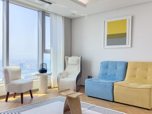 a living room with a couch and a chair at Brown Suites Busan Station in Busan