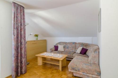 a living room with a couch and a table at Ferienwohnung Roth in Überlingen