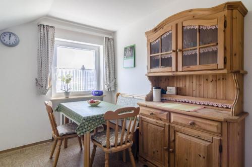 a kitchen with a table and a wooden cabinet at Ferienwohnung Roth in Überlingen