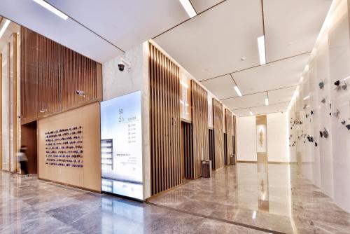 a hallway of a building with a person walking down it at 重庆Indition英迪逊高空酒店 解放碑来福士店 in Chongqing