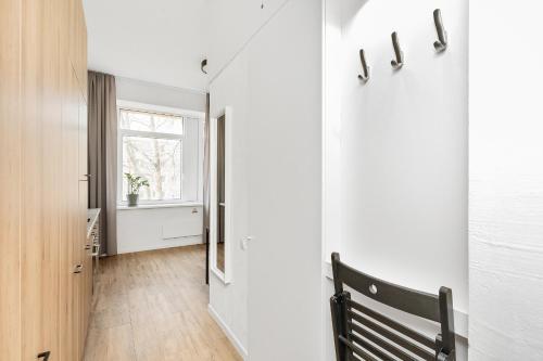 a hallway with a bench and a window at Air Apartments - Code entry only, No staff in Vilnius