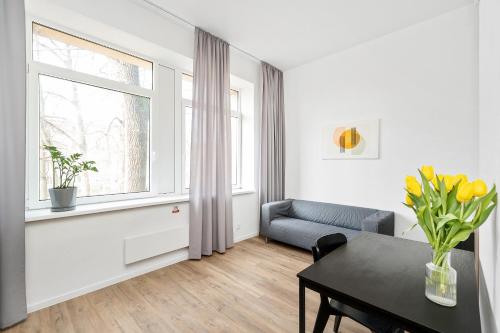a living room with a table and a window at Air Apartments - Code entry only, No staff in Vilnius