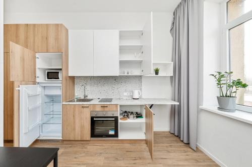 a kitchen with white cabinets and a counter top at Air Apartments - Code entry only, No staff in Vilnius