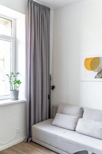a bed in a room with a window at Air Apartments - Code entry only, No staff in Vilnius