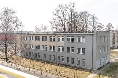 a large gray building in the middle of a field at Air Apartments - Code entry only, No staff in Vilnius