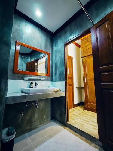 a bathroom with a sink and a mirror at Golden sand khaolak Resort in Khao Lak
