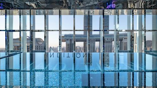 a swimming pool with a view of a city at 重庆Indition英迪逊高空酒店 解放碑来福士店 in Chongqing