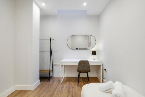 a white desk with a mirror and a chair at Luxury 5 Bedroom, 4 Bathroom Home in Purley in Purley
