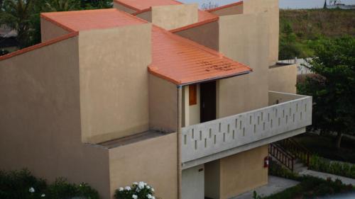 an external view of a building with a red roof at Luwansa Beach Hotel in Labuan Bajo