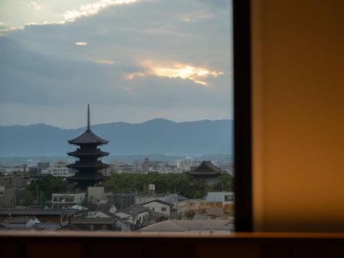 a view of a city from a window at Loisir Hotel Kyoto Toji in Kyoto