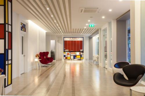 an empty hallway with red chairs and a room at THE KANNAS Hotel & Serviced Apartment, Chiang Mai SHA Certified in Chiang Mai