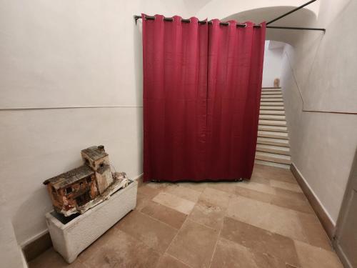a red shower curtain in a room with stairs at La Maison Royale in Toritto