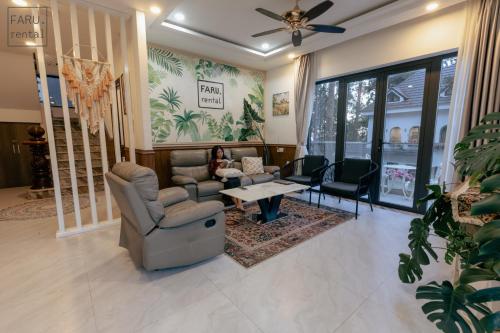 a living room with two chairs and a table at Faru Pine Woods Villa in Xuan An