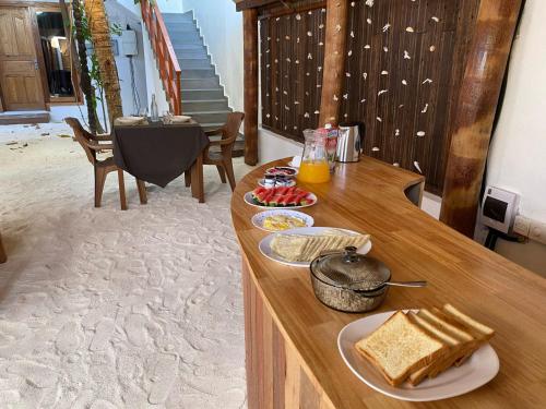 a wooden counter with food on top of it at INFINITE LAGOON in Mandhoo