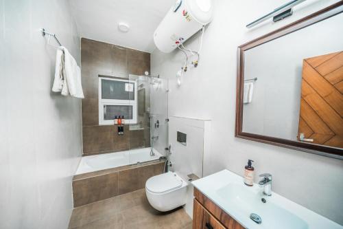a bathroom with a sink and a toilet and a mirror at Sagittarius by The StayCationer in Mussoorie