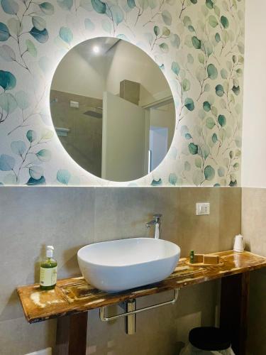 a bathroom with a white sink and a mirror at Palazzo Matà Boutique Hotel in Taranto
