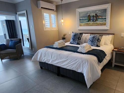 a bedroom with a bed with a picture on the wall at Frinton on Sea 12 in Ballito