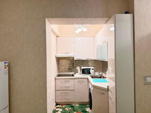 a kitchen with a sink and a refrigerator at Ub Friends Guest House in Ulaanbaatar